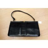 A vintage 1950's black lizard skin leather frame bag, shoulders strap, gold tone hard ware,
