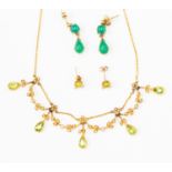 An Edwardian peridot and seed pearl necklace with foliate swags set with seed pearls to pearl cut