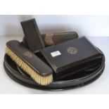 An ebony silver monogrammed dressing table set (mirror, tray, two brushes,