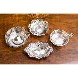 Four 20th century silver bon bon dishes, pierced with differing hallmarks for 1959, 1905 and 1935,
