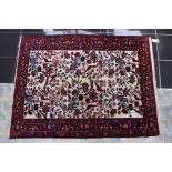 A Persian cream and red ground rug 14 cm x 114 cm
