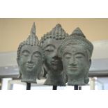 Three 20th Century Buddha's heads on stands