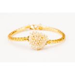 A pearl and 18ct gold bracelet, the heart shaped detail set with seed pearls to fancy link bracelet,