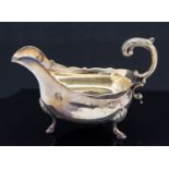 A George III silver sauce boat, acanthus C scroll handle on three stepped shell feel,