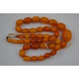 A butterscotch amber necklace, the largest bead approx 18mm x 14mm, smallest 8mm x 5mm,