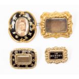 Four Victorian mourning brooches, three black enamelled "in memory of" one with scroll border,