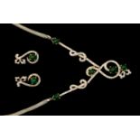 A diamond and emerald necklace, five cabochon emeralds claw set to grain set diamond scroll detail,