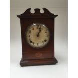 An early 20th Century American mahogany eight day mantle clock, white dial, Arabic numerals,