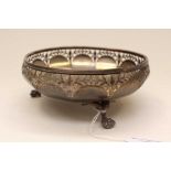 A George V Sterling silver three footed pierced bowl, faceted sides, raised on claw and ball feet,