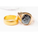 A 22 ct gold wedding band approx 8 gms, size M, and a 9 ct ring set with intaglio hematite,