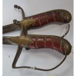 A pair of decorative swords with red leather wire bound grips,