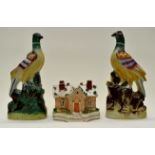 Pair of Victorian Staffordshire peacocks or birds of paradise along with a Staffordshire cottage