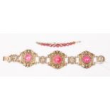 A Chinese silver three link bracelet, set with cabochons in pink,