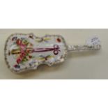 An early 20th Century European porcelain cello shaped trinket dish and cover