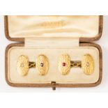 A pair of 18ct gold cufflinks, oval form, planish finish, flush set with diamond, sapphire and ruby,