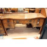 A George III mahogany serpentine bowed sideboard, central long drawer on square tapered supports.