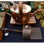 A copper watering can,