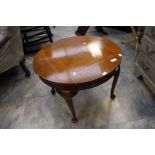 Round mahogany coffee table raised on cabriole legs.