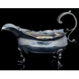 A George II silver sauce boat, double C scroll handle, triple trefid feet, maker John Munns,