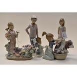 Four Lladro figures of girls and cats,