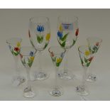 Five hand painted stemmed schnapps glasses together with two hand painted wine glasses,