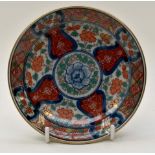 An Imari shallow dish typically decorated