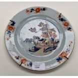 An 18th Century porcelain plate decorated in an Oriental style with cobalt blue and iron red,