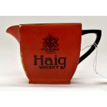 A Carlton Ware Haig whisky jug, early 20th Century, black decoration on a red ground,