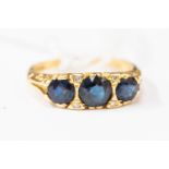 A Victorian sapphire and diamond ring, comprising three round sapphires, with diamond accents,