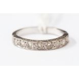 A diamond half hoop ring set with seven diamonds each approx 0.