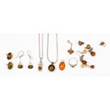 A collection of silver amber set jewellery to include an owl pendant with chain,