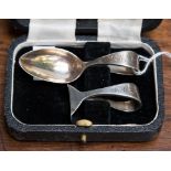 A George VI silver child's serving spoon and pusher set in original case,