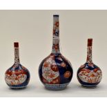 Three Japanese bottle necked vases typically decorated in Imari colours,