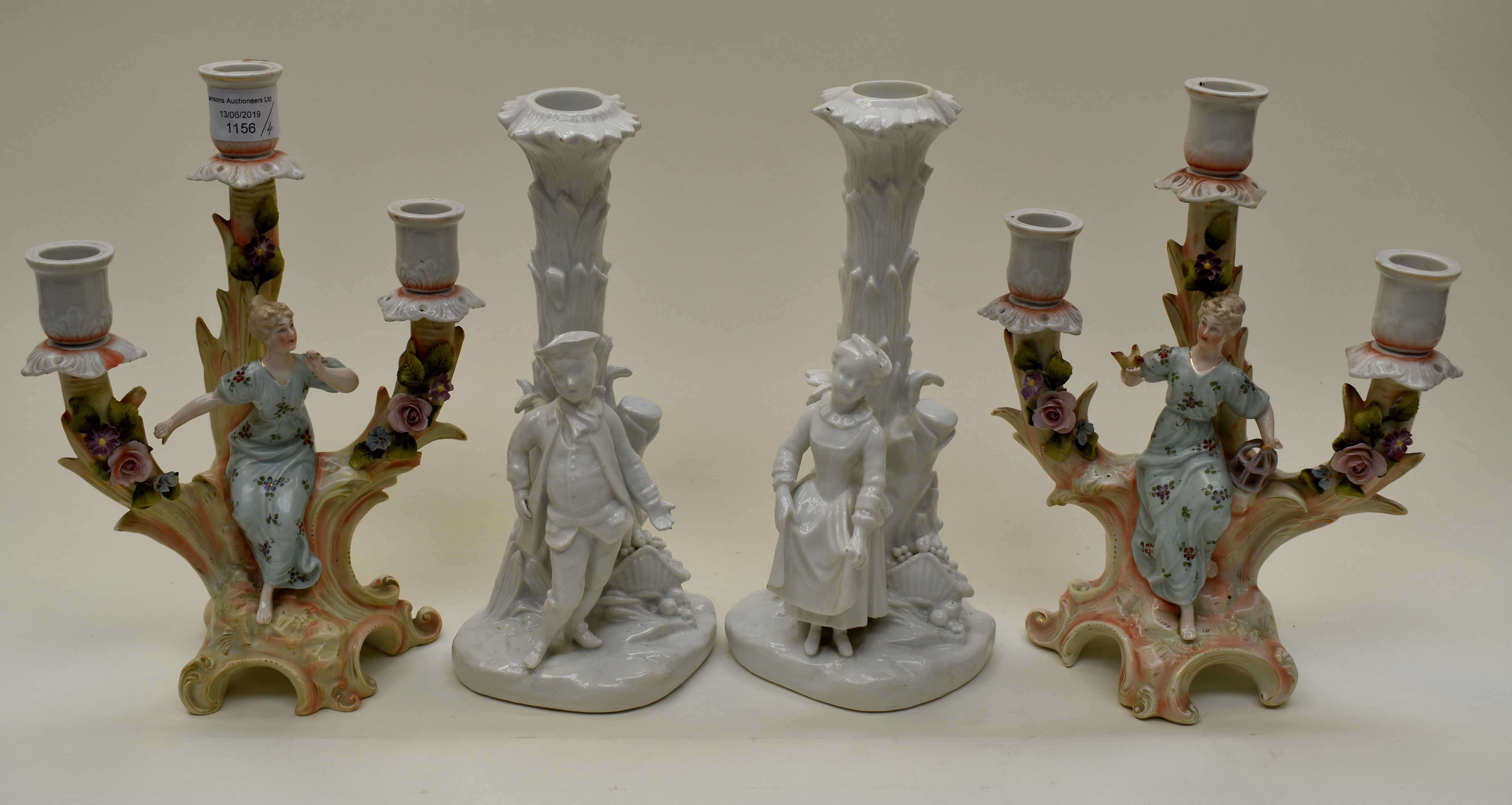 Two pairs of ceramic candlesticks,