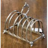 A George VI silver six tier toast rack, arched form with foliate moulded oval handle,