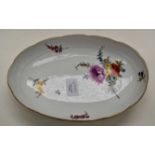A Meissen oval side dish with altozier relief, a bouquet of flowers and strewn flowers, gilt rim,