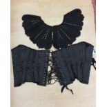 A lady's black corset, boned and studded, back and front laces, size 26,