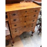 A first quarter 20th century Georgian style reproduction mahogany and walnut chest of drawers.