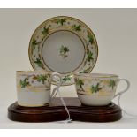 A Pinxton trio, pattern 312, including coffee can, saucer and tea cup, decorated in gold and green,