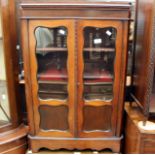 A small mahogany display cabinet.