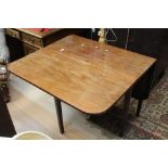 A George III mahogany drop leaf dining table, fitted with two leaves,