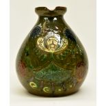 Studio pottery jug with floral design with green glaze Condition: Minor chips to tip of spout.