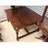 An early 20th century solid oak dining table,