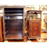 An open chip carved four tiered cabinet together with an oak cupboard geometrically panelled.