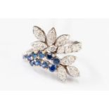 A diamond and sapphire fancy cluster,18 ct white gold ring, stylized leaf and scroll design,