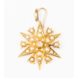 A Victorian 15ct gold and seed pearl star pendant set to the centre with a diamond, approx 0.