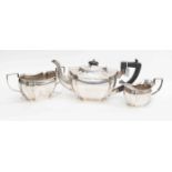 An Art Deco silver three piece tea set, shaped bodies with fluted section,