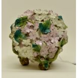 A porcelain flower ball, raised on bark effect feet, the lozenge mark indicates a date for 1858,