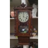 A late 19th Century salon wall clock in-laid Roman numerals,