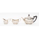 A Victorian silver three piece tea service, oval and semi fluted, Sheffield 1897/1897, John Round,